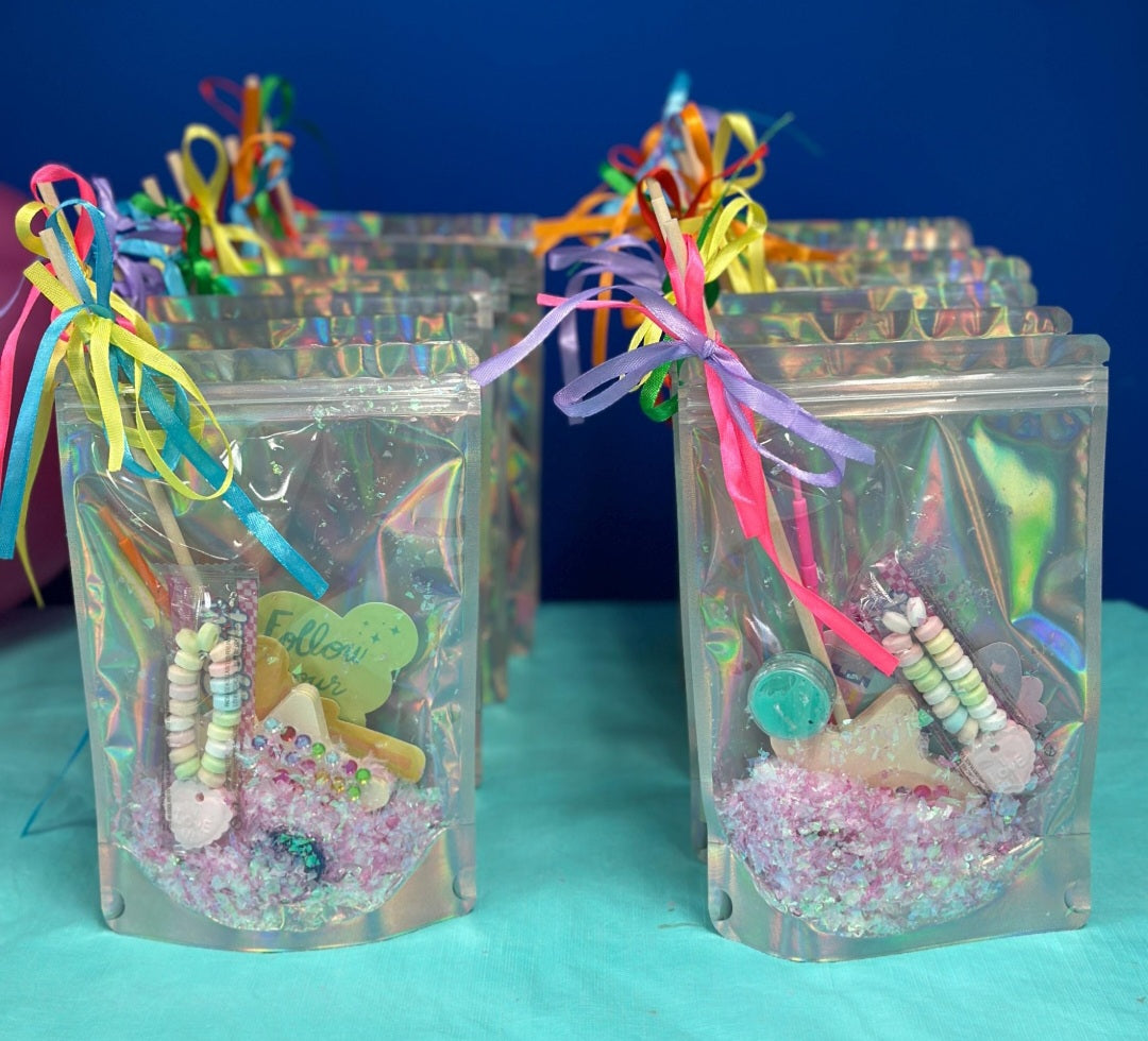 Cute Party favors.  Silver clear bags filled with fairy dust, wooden fairy wand, paints and gems and colourful ribbon