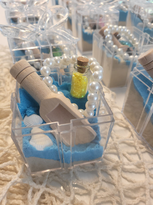 Mermaid under the sea party bag.  Sensory kit. Tuff tray.  Clear box,filled with half blue sand and clear kinetic sand, a scoop to play, seashells, glitter message in a bottle, and pearl treasure braclet